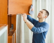 man cleaning wooden furniture