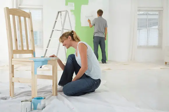 Couple painting home interior