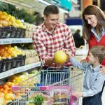 Family with child shopping fruits