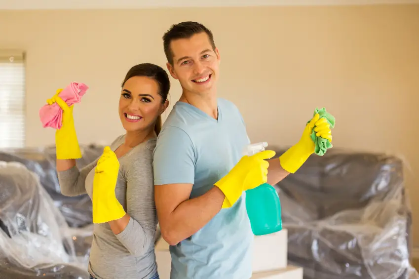 young couple cleaning their new house