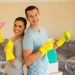 young couple cleaning their new house