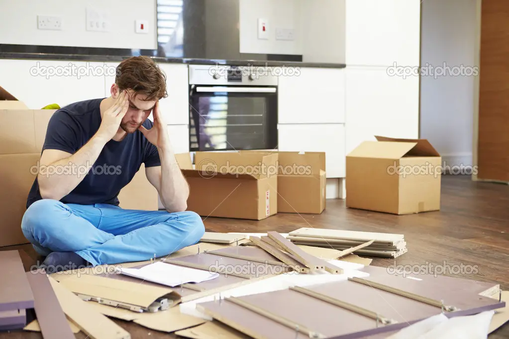 Frustrated Man Putting Together Self Assembly Furniture