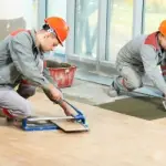 Two tilers at industrial floor tiling renovation