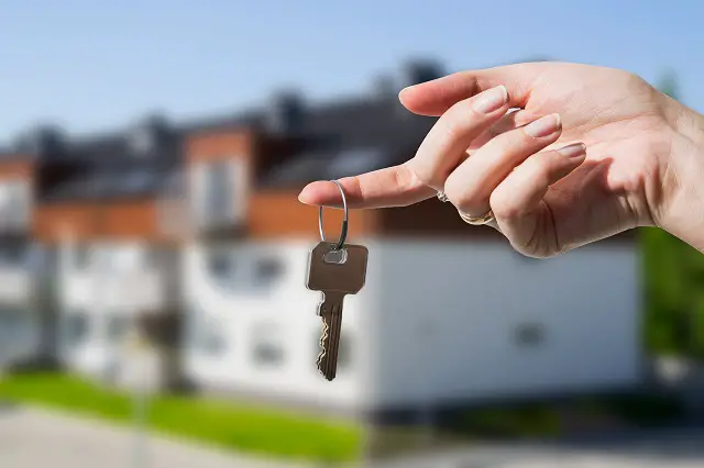 Woman's hand holding keys to new house